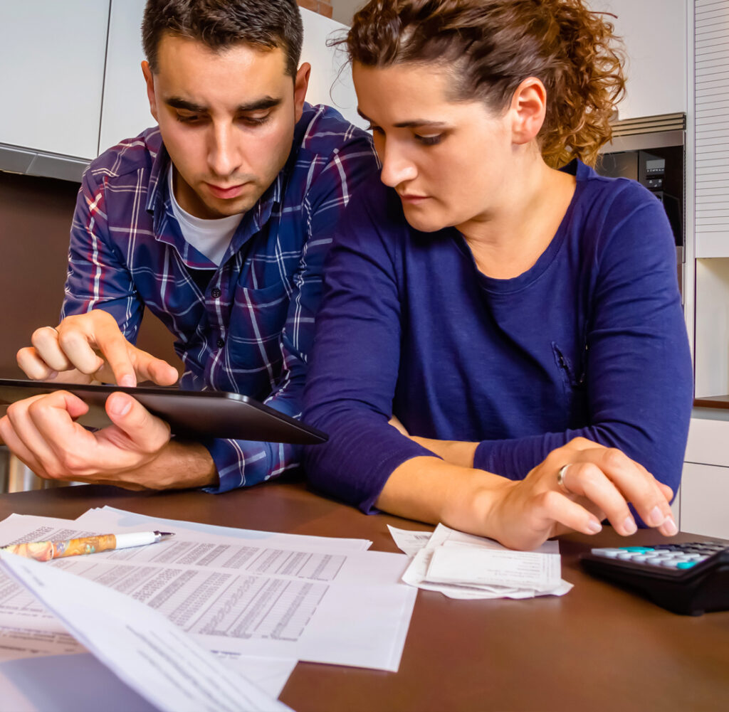Two adults working on math together