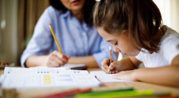 A child psychologist conducts a learning evaluation with a student.