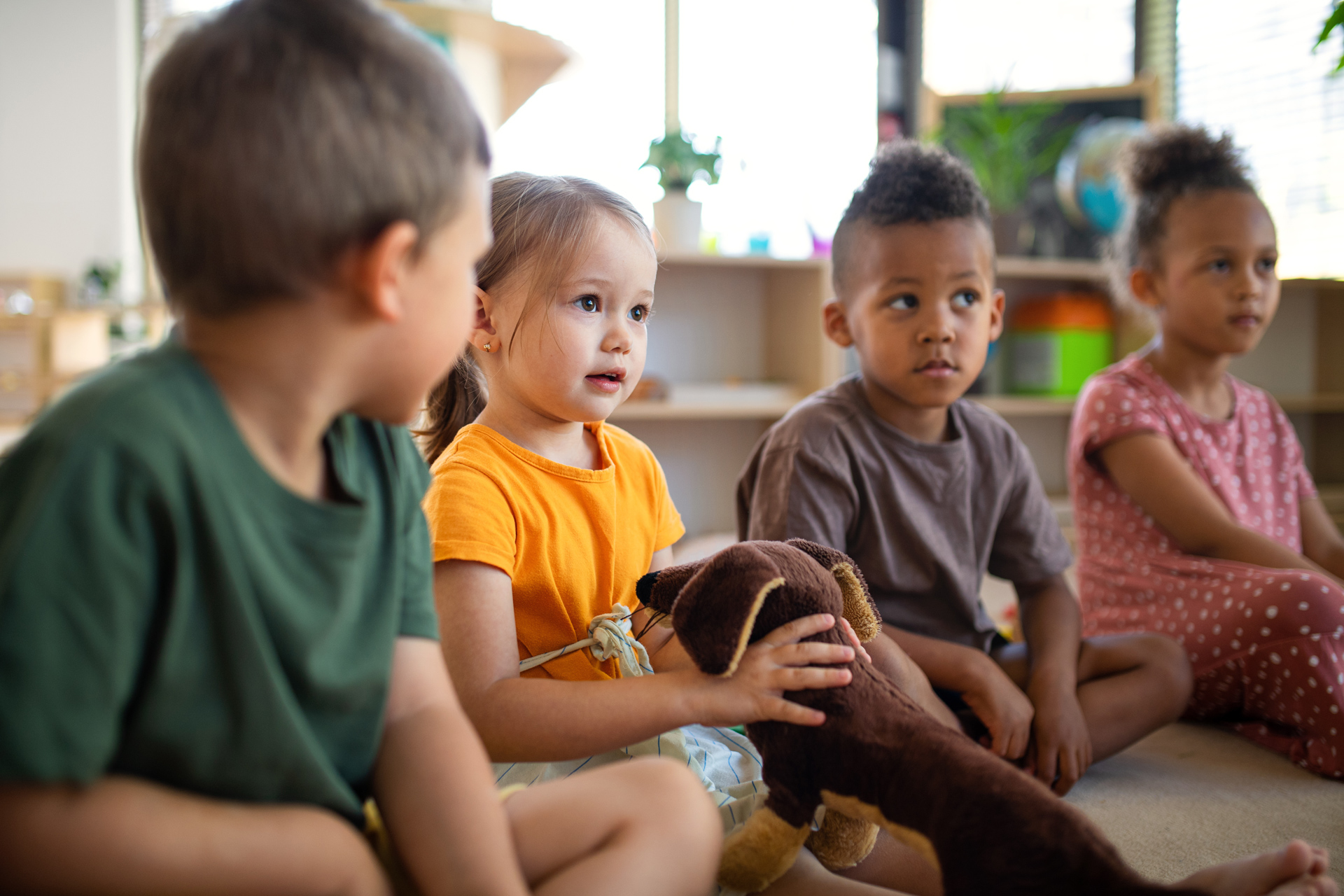 Attentive group of young children in a classroom