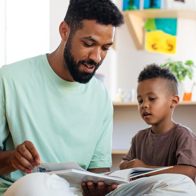 Adult reading to young child