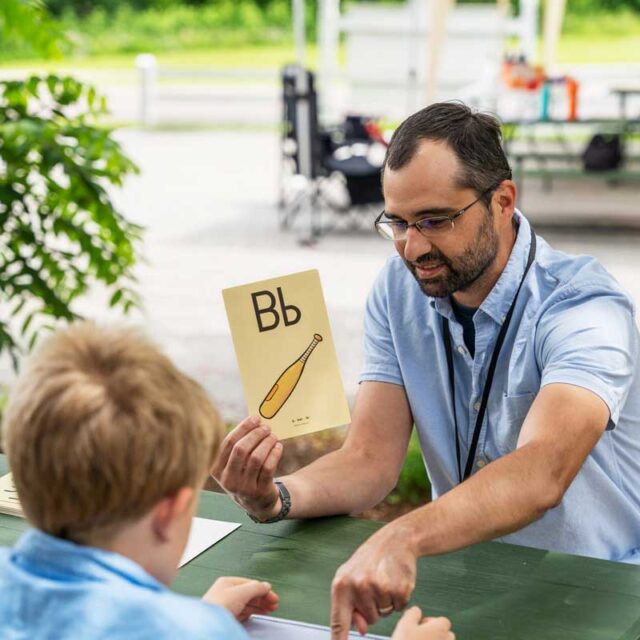 Photo of a Stern Center instructor providing tutoring services to a student outside.