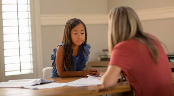 A reading instructor helps a student during a lesson.