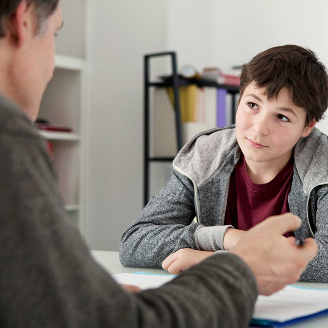 Student listens to a teacher in a one-on-one lesson.