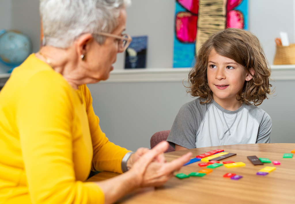 An instructor teaches a multisensory math lesson to a student