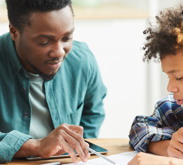 Male teacher helping student